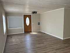 Main entrance to living room. Room darkening honeycomb shades on west side of home